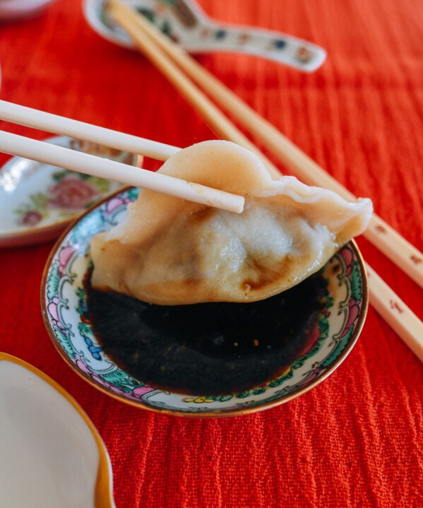 dipping beef dumpling into Chinese black vinegar