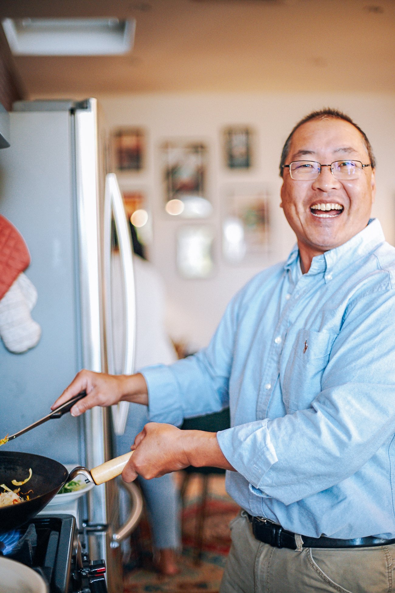 Bill cooking at the stove in Sarah's apartment