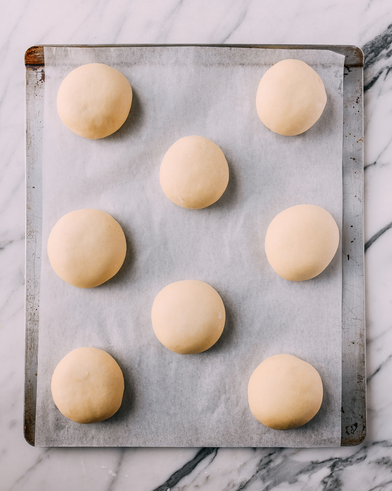 Shaped char siu bao on baking sheet