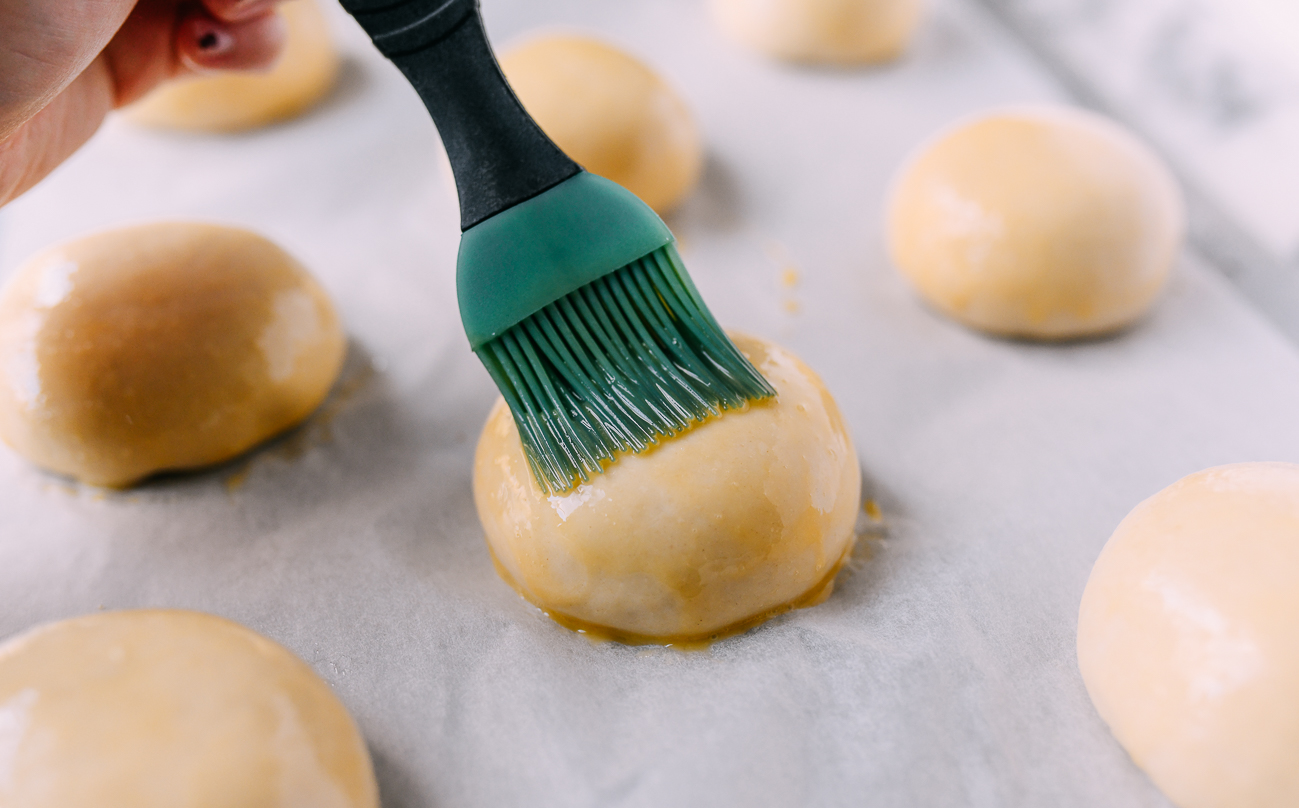 Brushing bun with egg wash