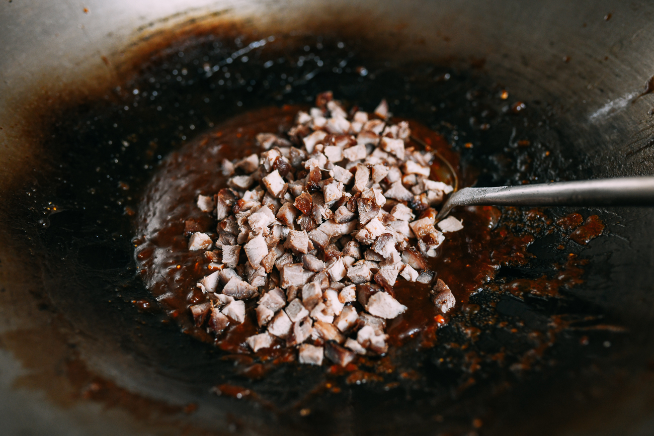 Stirring diced roast pork into Chinese BBQ Pork Bun filling