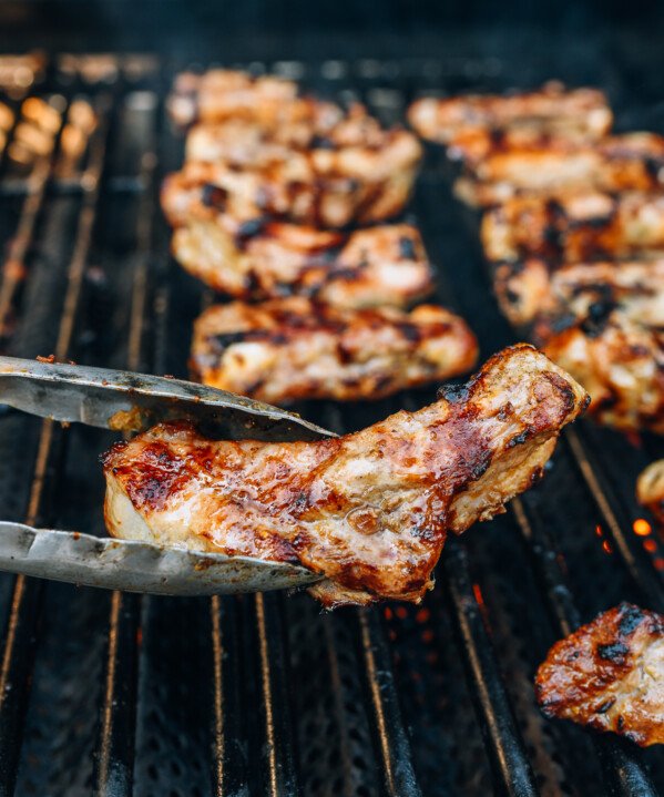 grilling individual ribs with metal tongs