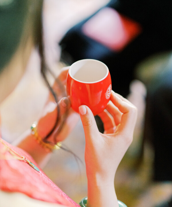 Sarah holding cup of tea during Chinese wedding tea ceremony