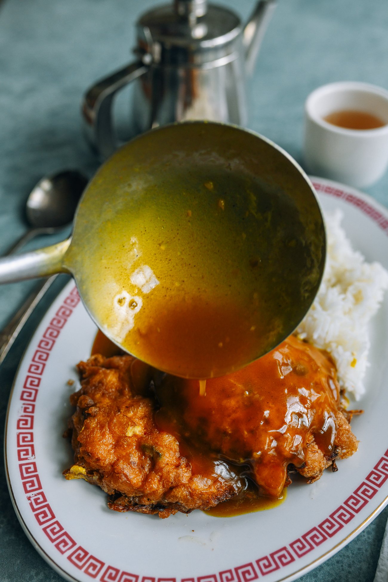 pouring gravy over egg foo young