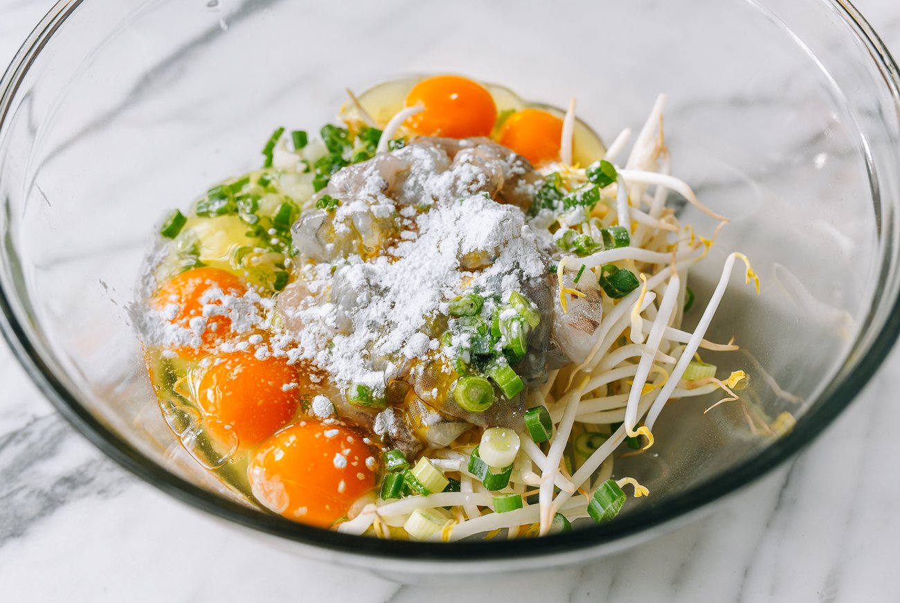 ingredients for egg foo young batter in glass mixing bowl