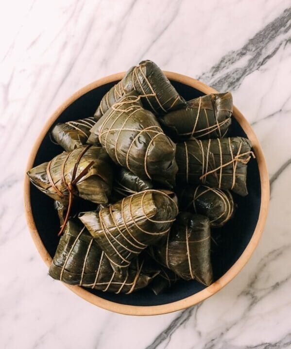 Wrapped Cooked zongzi (Sticky Rice Dumplings), by thewoksoflife.com