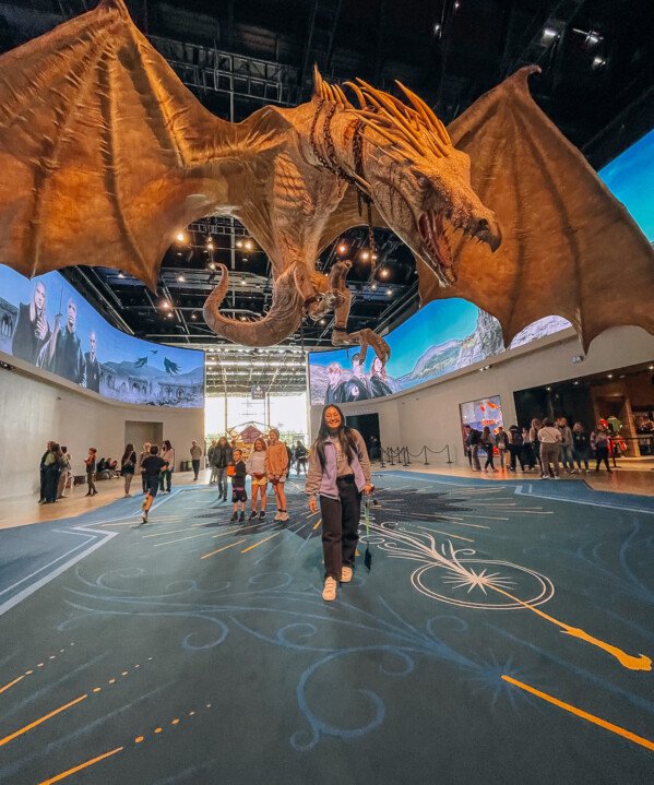 Kaitlin underneath a giant Ukrainian Ironbelly dragon from Harry Potter and the Deathly Hallows