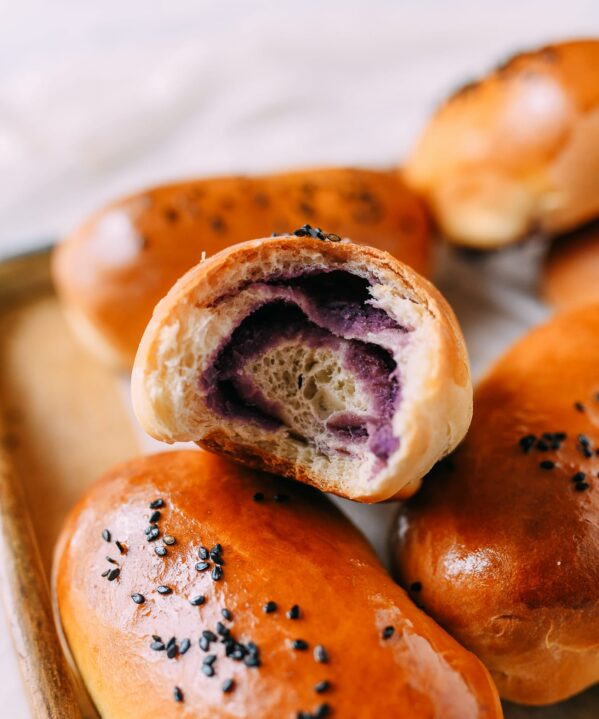 Ube bun with a bite taken out of it