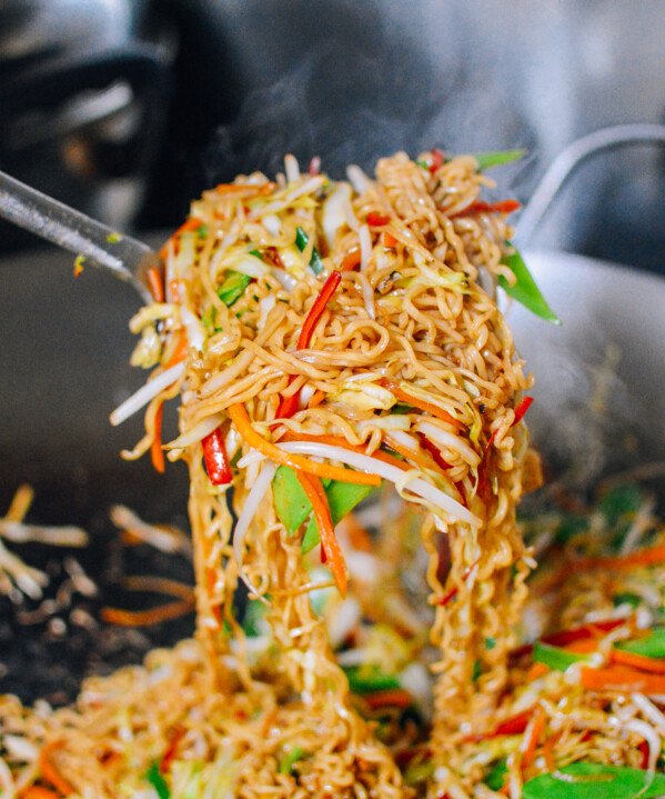 Picking up vegetable ramen noodle stir-fry