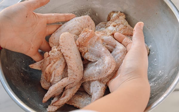 Tossing chicken wings with dry spices, thewoksoflife.com